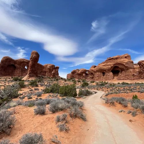 Red rock arch formations under a blue sky at Arches National Park